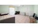 Versatile bedroom space featuring tile floors, neutral tones, and ample space for both sleep and work at 1216 Yawl Way, Venice, FL 34285