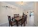 Cozy dining room featuring a wood table, chairs, and a view into the living room at 1216 Yawl Way, Venice, FL 34285