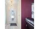 Clean entryway with a decorative front door and a pop of color on the accent wall at 1216 Yawl Way, Venice, FL 34285