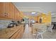 Lovely eat-in kitchen with granite countertops, wooden cabinets, and a convenient breakfast bar at 1216 Yawl Way, Venice, FL 34285