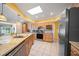 Bright kitchen with stainless steel appliances, granite counters, and ample cabinet space at 1216 Yawl Way, Venice, FL 34285