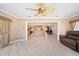 Open-concept living room with tile floors leading into an adjacent kitchen and dining room at 1216 Yawl Way, Venice, FL 34285