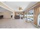 Spacious living room with tile floors, comfortable seating, and views of the pool area at 1216 Yawl Way, Venice, FL 34285
