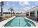 Sparkling pool with a screen enclosure, hot tub and lush landscaping, perfect for relaxation and recreation at 1216 Yawl Way, Venice, FL 34285