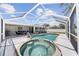 Screened-in pool and spa with a large patio for outdoor lounging and entertaining at 1216 Yawl Way, Venice, FL 34285