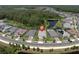Aerial view of the property with a peaceful pond nearby, offering a serene setting and great curb appeal at 12617 Wetmore Ct, Odessa, FL 33556