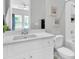 White bathroom with white cabinets, quartz countertop, toilet and bath/shower combo at 12617 Wetmore Ct, Odessa, FL 33556