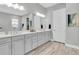 Elegant bathroom featuring double sinks, a large mirror, and plenty of counter space for getting ready at 12617 Wetmore Ct, Odessa, FL 33556