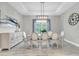 Elegant dining room with a modern light fixture, six chairs, and a matching sideboard at 12617 Wetmore Ct, Odessa, FL 33556
