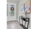 Inviting foyer features a decorative door with sidelights and a console table with decorative artwork at 12617 Wetmore Ct, Odessa, FL 33556