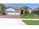 Charming single-story home with a three-car garage, well-manicured lawn, and fresh landscaping at 12617 Wetmore Ct, Odessa, FL 33556
