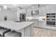 Modern kitchen with stainless steel appliances, a large island, and stylish pendant lights at 12617 Wetmore Ct, Odessa, FL 33556