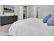Bright main bedroom with a neutral color scheme, a dresser, and a TV for a relaxing retreat at 12617 Wetmore Ct, Odessa, FL 33556