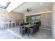 Outdoor kitchen and dining area with grill, sink, and ample seating at 12617 Wetmore Ct, Odessa, FL 33556