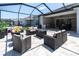 Inviting outdoor patio featuring comfortable seating, a fire pit, and a built-in grilling station for relaxing and entertaining at 12617 Wetmore Ct, Odessa, FL 33556