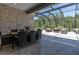 Covered patio featuring an outdoor dining area and comfortable seating space at 12617 Wetmore Ct, Odessa, FL 33556