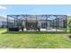 A spacious screened-in lanai offers ample seating and dining areas, perfect for outdoor entertaining at 12617 Wetmore Ct, Odessa, FL 33556
