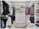 Spacious walk-in closet offering ample storage, custom shelving, and a stylish bench for added convenience at 12617 Wetmore Ct, Odessa, FL 33556