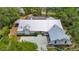 Bird's eye view of the house, highlighting the well-maintained metal roof and driveway at 1276 Meredith Dr, Spring Hill, FL 34608