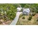 A high angle shot of the residence featuring a large driveway and green lawn at 1276 Meredith Dr, Spring Hill, FL 34608
