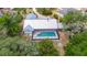 This home includes a screened pool and an easy-to-maintain metal roof, surrounded by mature trees at 1276 Meredith Dr, Spring Hill, FL 34608