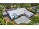 An aerial view of the home featuring a screened-in pool and metal roof at 1276 Meredith Dr, Spring Hill, FL 34608