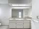 Bright bathroom featuring a double vanity with framed mirror and tiled countertop at 1276 Meredith Dr, Spring Hill, FL 34608