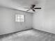 Bedroom featuring gray carpet, ceiling fan, window, and white walls at 1276 Meredith Dr, Spring Hill, FL 34608