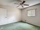 Bedroom featuring green carpet, ceiling fan, window, and light pink walls at 1276 Meredith Dr, Spring Hill, FL 34608