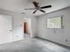 Bedroom featuring gray carpet, ceiling fan, window, and white walls at 1276 Meredith Dr, Spring Hill, FL 34608