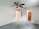 Bedroom featuring gray carpet, ceiling fan, and white walls at 1276 Meredith Dr, Spring Hill, FL 34608