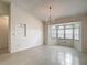 Bright dining area featuring a chandelier, bay window and tile flooring at 1276 Meredith Dr, Spring Hill, FL 34608