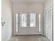 Elegant entryway featuring decorative glass doors, tile flooring, and closet at 1276 Meredith Dr, Spring Hill, FL 34608