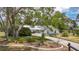 Charming single-story home with a long driveway and mature landscaping at 1276 Meredith Dr, Spring Hill, FL 34608