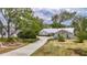 Charming single-story home with a well-manicured lawn, driveway and landscaping at 1276 Meredith Dr, Spring Hill, FL 34608