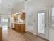 Kitchen with wood cabinets and views of the living room and dining room at 1276 Meredith Dr, Spring Hill, FL 34608