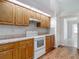 Charming kitchen offers warm wood cabinetry, neutral counters, and a stylish tile backsplash at 1276 Meredith Dr, Spring Hill, FL 34608