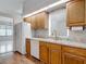 Well-lit kitchen features wood cabinets, stainless steel sink and adjacent dining area at 1276 Meredith Dr, Spring Hill, FL 34608