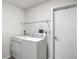 This laundry area has a utility sink and white appliances to make laundry convenient at 1276 Meredith Dr, Spring Hill, FL 34608