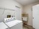 The laundry room includes a sink, storage shelves, and modern washer and dryer hookups for added convenience at 1276 Meredith Dr, Spring Hill, FL 34608