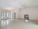 An open-concept living room featuring tile flooring, a fireplace and a chandelier at 1276 Meredith Dr, Spring Hill, FL 34608