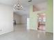 Open-concept living area featuring tile flooring, a chandelier, and access to the kitchen at 1276 Meredith Dr, Spring Hill, FL 34608