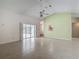 Open concept living room with tile floors and sliding glass doors to the patio at 1276 Meredith Dr, Spring Hill, FL 34608