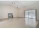 Bright living room featuring tile floors, a fireplace, sliding doors, and a ceiling fan at 1276 Meredith Dr, Spring Hill, FL 34608