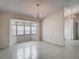 Bright living room with a bay window, chandelier, and tile floors at 1276 Meredith Dr, Spring Hill, FL 34608