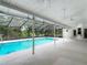 A screened-in pool area with a deck provides privacy and a refreshing escape from the Florida heat at 1276 Meredith Dr, Spring Hill, FL 34608