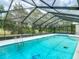 Inviting screened pool with clear blue water and surrounding patio, perfect for relaxation and entertainment at 1276 Meredith Dr, Spring Hill, FL 34608