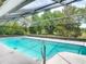 Screened-in pool with crystal-clear water, perfect for relaxation and entertainment at 1276 Meredith Dr, Spring Hill, FL 34608