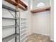 Storage room featuring metal and wooden shelves and a tile floor at 1276 Meredith Dr, Spring Hill, FL 34608