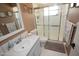 Bathroom with earth-toned walls, shower with glass doors, vanity and sink at 13100 Fish Cove Dr, Spring Hill, FL 34609